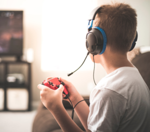 boy plays video game as reward for summer assignment competition