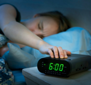 set alarm clock to ease back into school routine